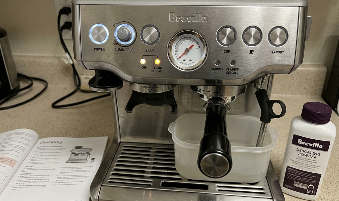 Breville Barista Express control panel with the CLEANDESCALE light illuminated, ready for descaling